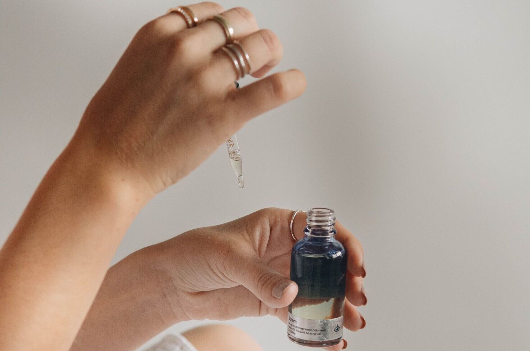 person holding black glass bottle